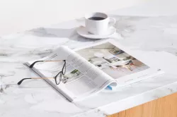 A magazine next to cup of coffee 3D model