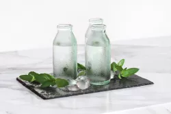 Glass bottles with water standing on a pad 3D model