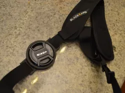 Lens cap holder for both 58 and 52 mm lens diameters