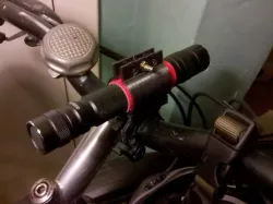 Flashlight grip for sliding bike handlebar mounts