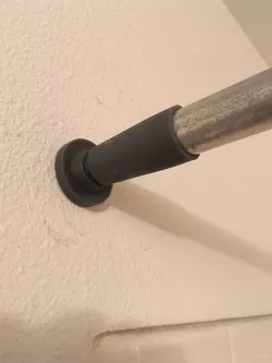 Shower curtain rod tensioner