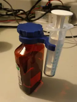 Medical bottle cap and syringe support