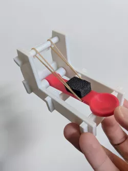 Better rubber band holder for toy catapult