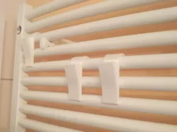 Towel hanger for the bathroom heater