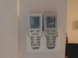 two air conditioner remotes wall mount