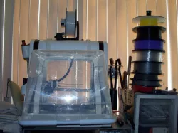 Robo 3D R1 plastic enclosure with support straps.