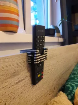 Holder remote control on bed with visualization cat and dog