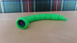 Big snake eats small snake toy