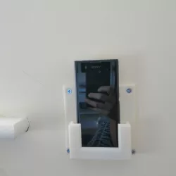Wall mounted phone holder