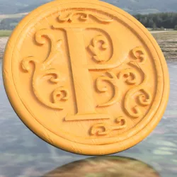 Coaster with letter 'P'