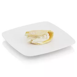 Bitten griddle cake with cream