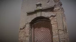 Old crumbling gate / door with relief decoration