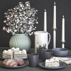 A set of dishes with a croissant and cake 3D model