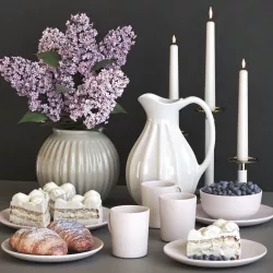 A set of dishes with a croissant and cake and lilac 3D model