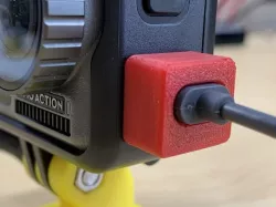 Dust cap with USB-C cable slot for DJI Osmo Action