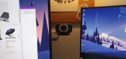 Hideable webcam mount behind monitor