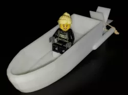 Rubber-band powered paddle boat with Lego seat