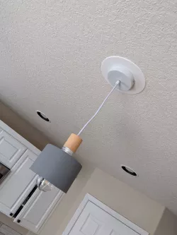 Cover plate for adapting a can light to a pendant light