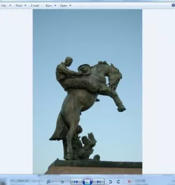 bucking bronco and a steadfast cowboy in wool chaps