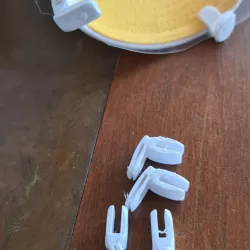 Face shield holders for caps