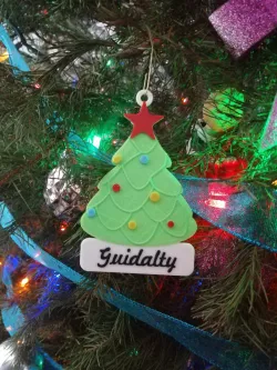 Christmas tree decoration in the shape of a pine tree with star and spheres