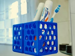Toothbrush/toothpaste holder