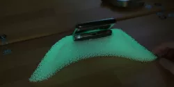 Qi charger desk stand/placement aid that glows in the dark