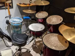 Drum rack holders for sticks, tuning key, and headphones.