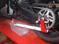 Motorcycle chain lube drain