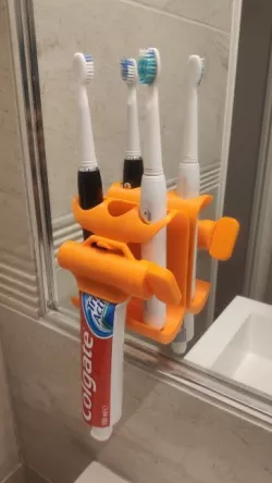 Toothpaste squeezer and toothbrush holder
