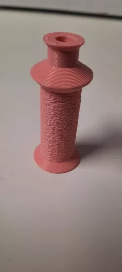 Spool with winding aid to rewind smaller spools from serger cones