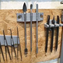 Wall mounted bracket for metal scrapers / shapers