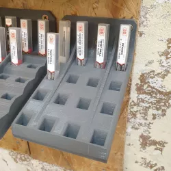 Wall mounted bracket for small tooling in packaging (square cross-section)