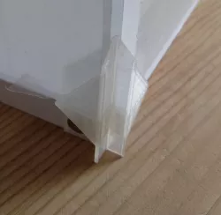 Corner for display box consisting of chip board base and 5mm acryl sides