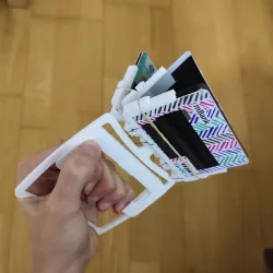 Springloaded book-like wallet with a trigger