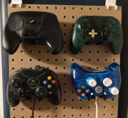 Pegboard game controller holder