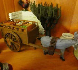 A cart with crates of vegetables and fruits