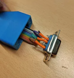 DB-9 connector housing for flat ribbon cable