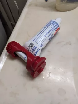 ratcheting toothpaste squeezer with release.