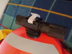 Flashlight support for firefighter helmet.
