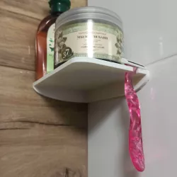 Shower shelf with shaver hook