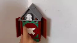 A wall clock with hidden doors and a bird coming out