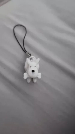 key ring Snowy chewing on a bone