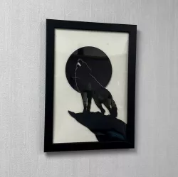 Silhouette of a wolf howling at the moon for frame