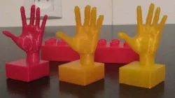 Hand on duplo-compatible block