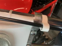Cable or hose attachment for motorcycle fork.