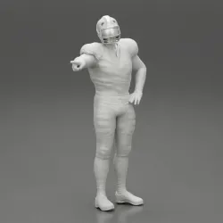 Rugby player standing pointing to the ball