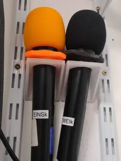 Wall bracket for a wireless hand microphone