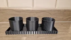 Trio of modern plant pots with drip trays