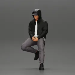 Man in a hooded sweatshirt and cap leaning on the car